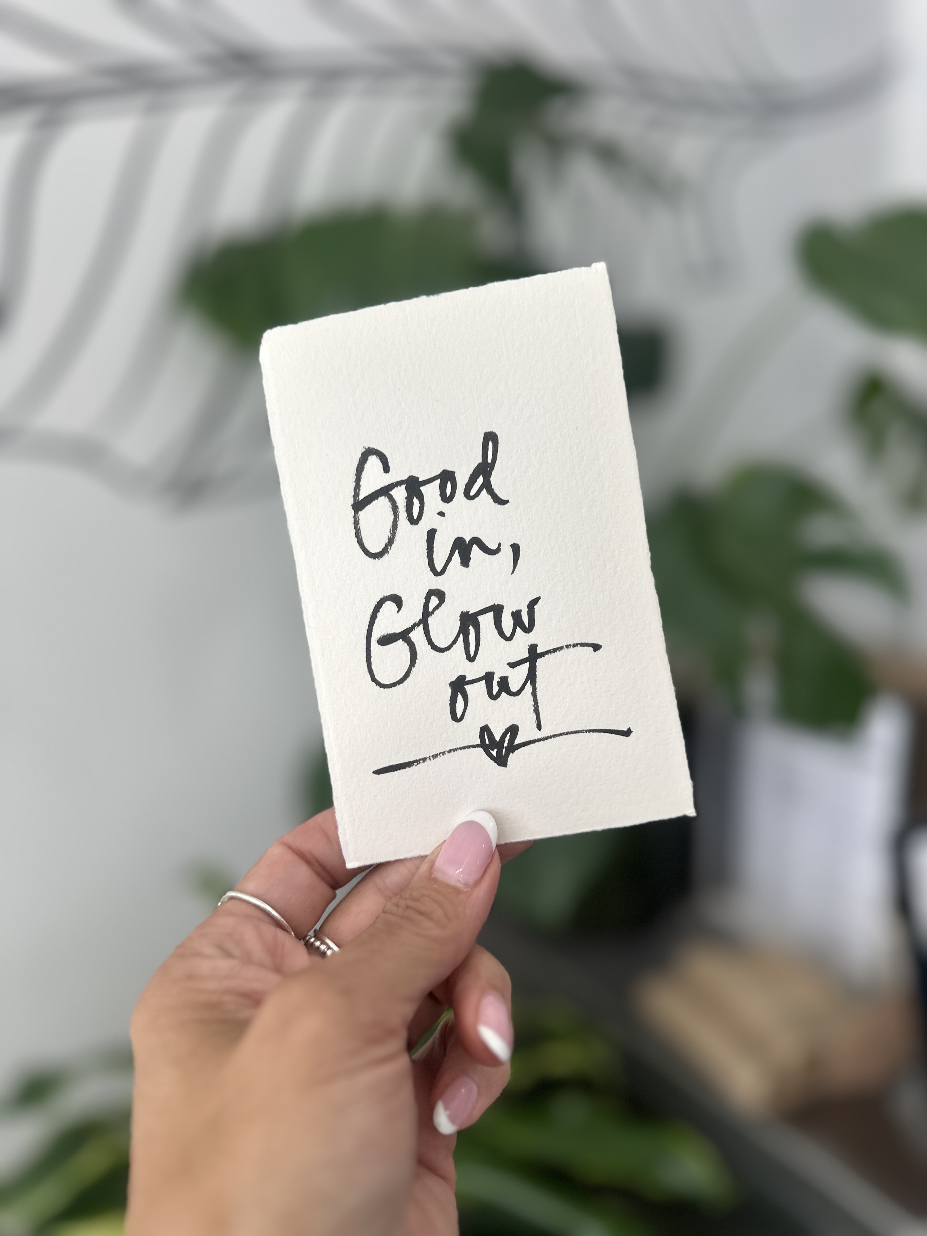 Hand-lettered card reading Good in, Glow out